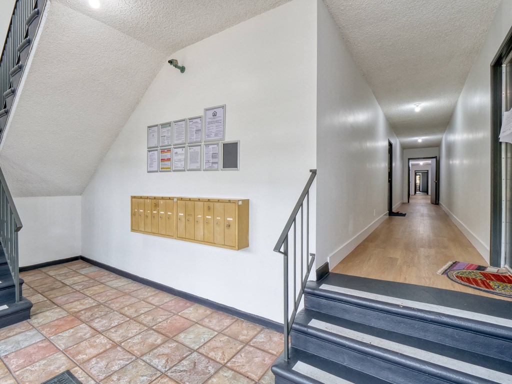 the view from the top of the stairs into the hallway of a house with stairs