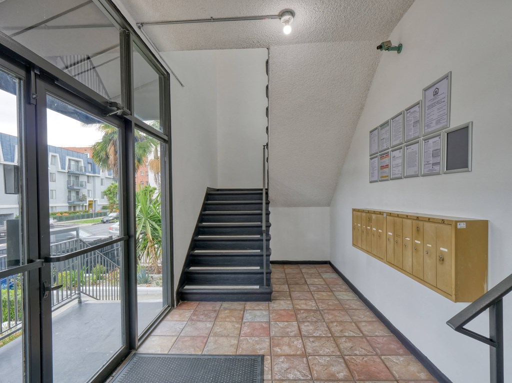 the stairway up to the second floor of a building with a large glass door