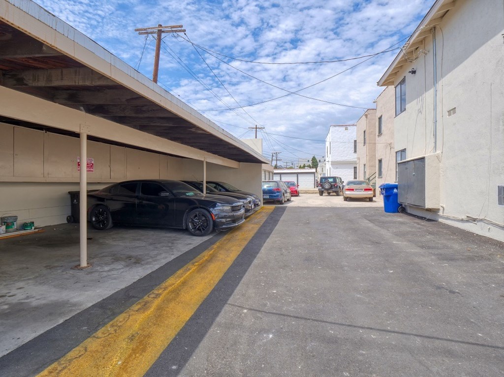 a parking lot with cars parked outside of a building
