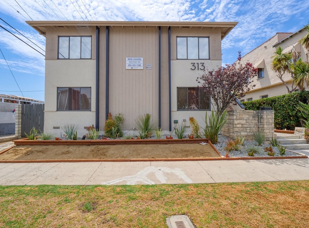 a house with a yard and a sidewalk in front of it