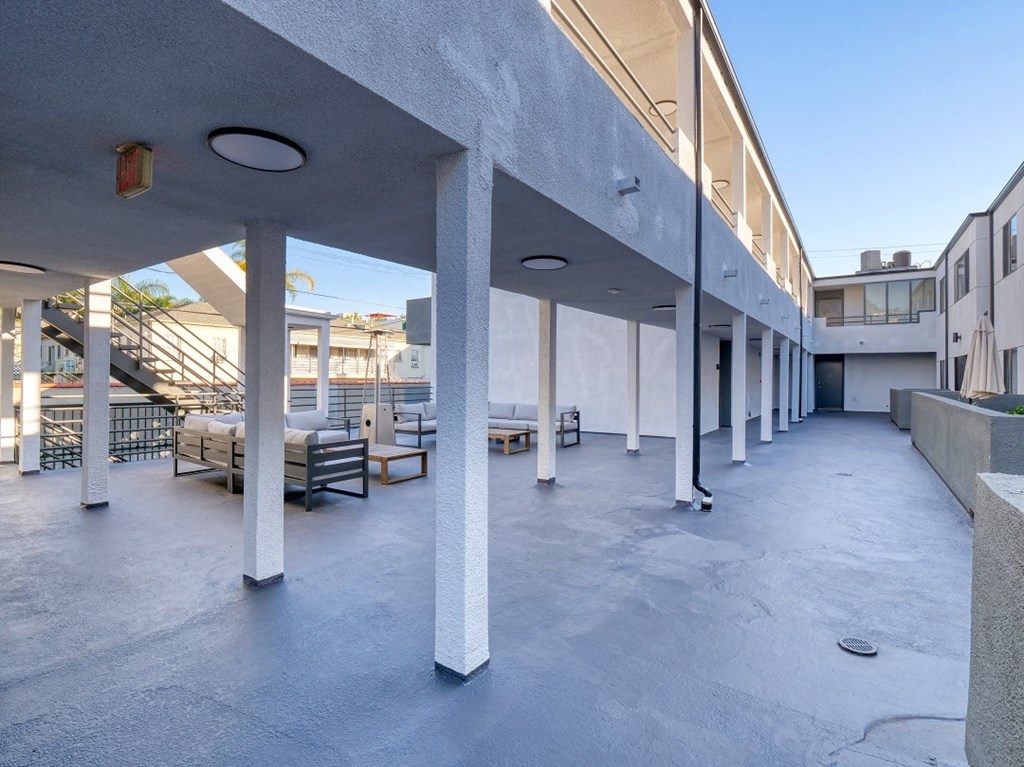 the lobby of a building with benches and columns