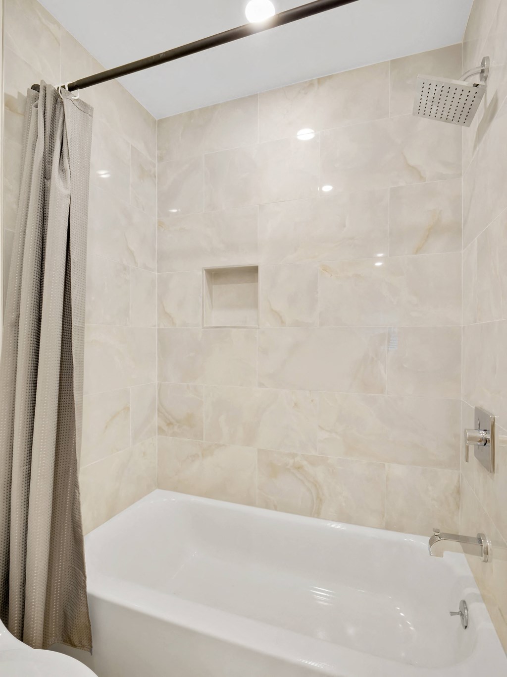 a bathroom with a bathtub and shower in a 555 waverly unit