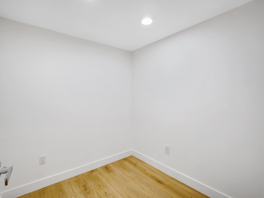 a room with white walls and a wooden floor