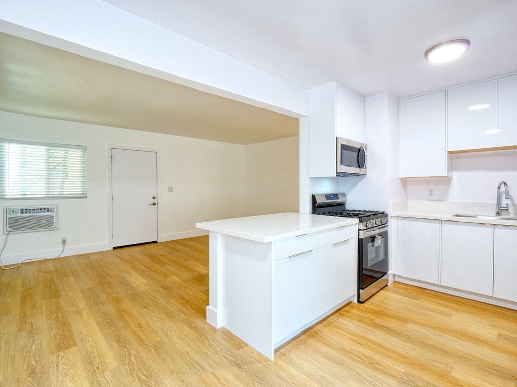 a kitchen with white cabinets and a white counter top