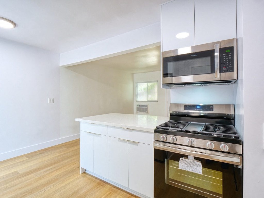 a kitchen with a stove and a microwave