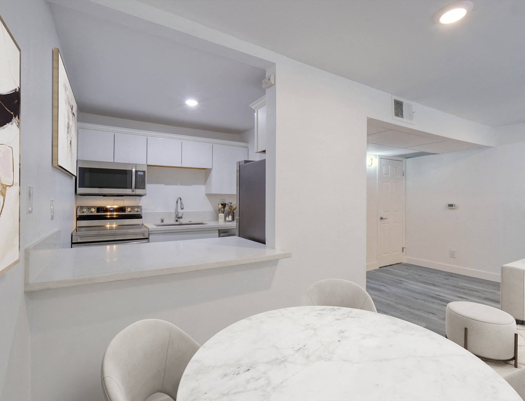 a kitchen and dining area with a table and chairs