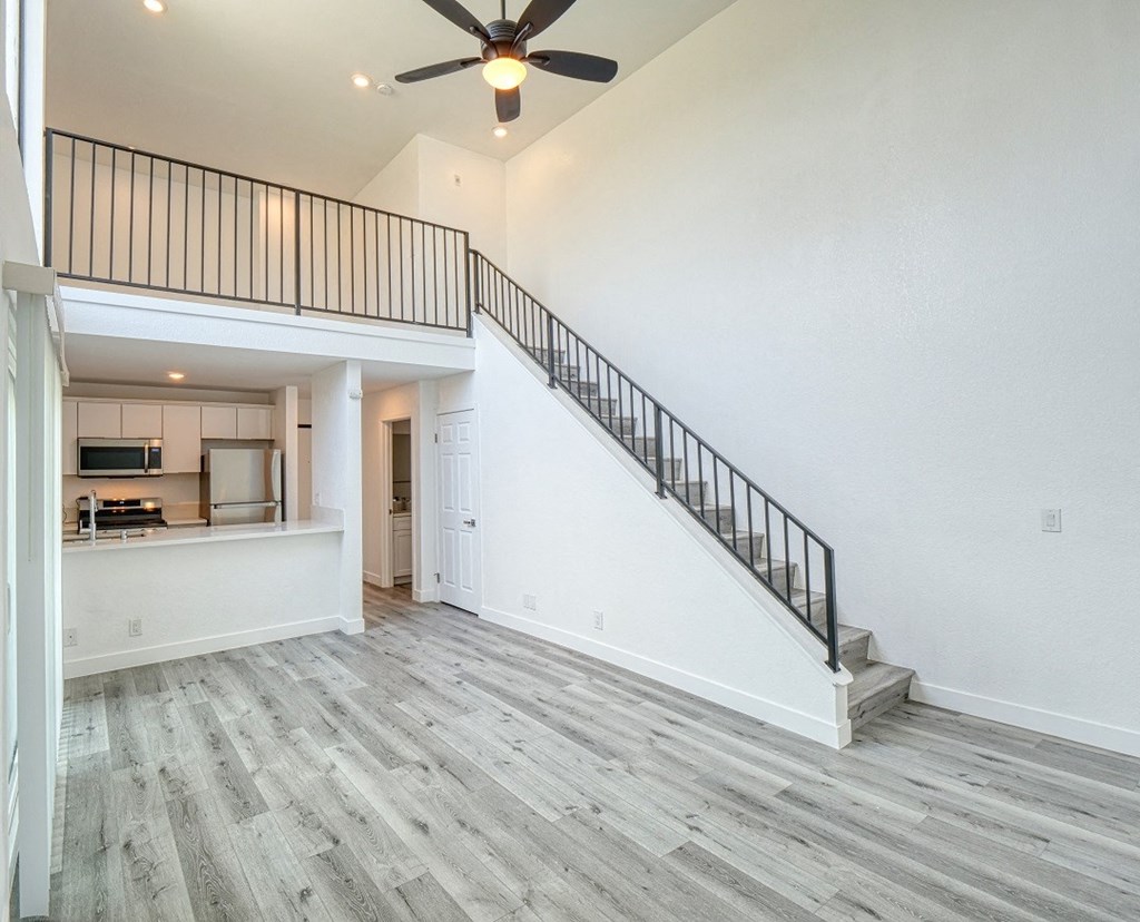 the spacious living room is open to the kitchen and staircase to the second floor