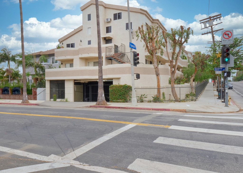 an apartment building on the corner of a street