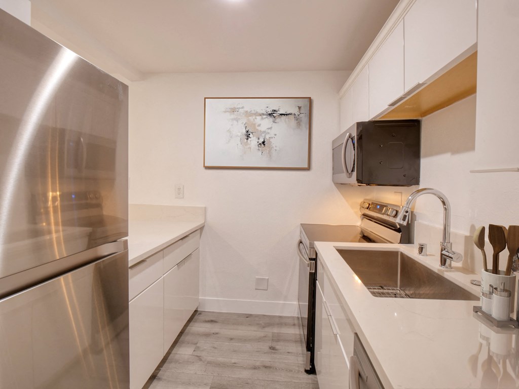 a kitchen with stainless steel appliances and a sink