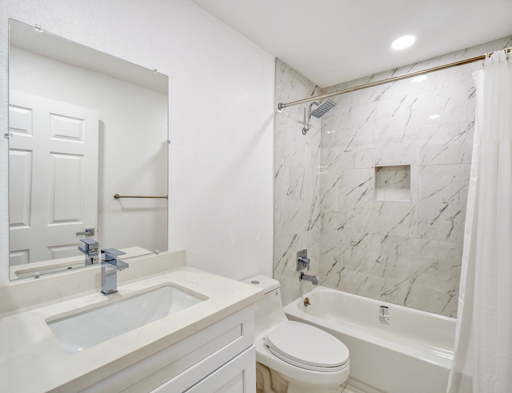 a bathroom with a sink toilet and a shower