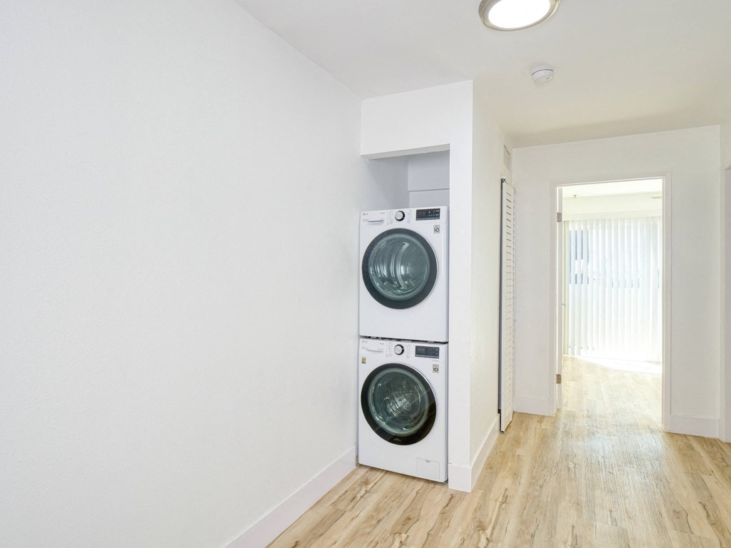 a white laundry room with a washing machine and a dryer