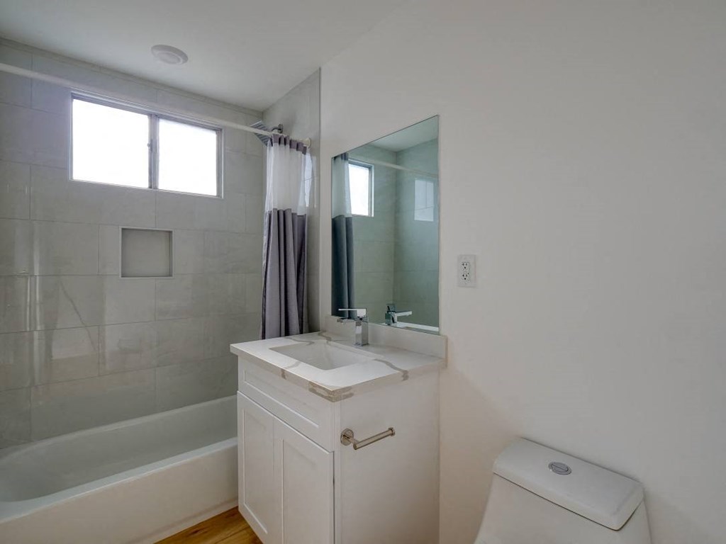 a bathroom with a sink toilet and a shower