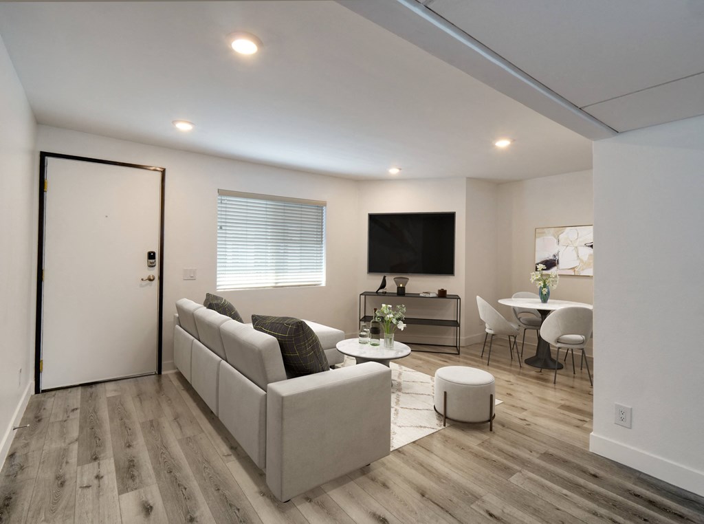 a living room with a couch and a table and a tv
