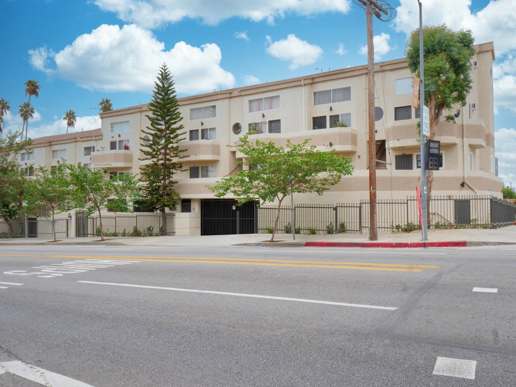an empty street in front of an apartment building