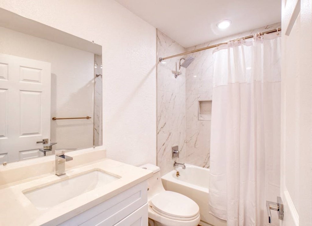 a bathroom with a sink toilet and a shower