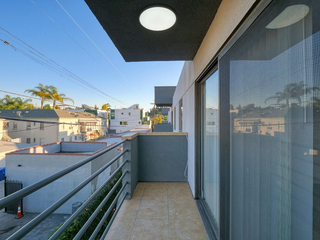 a view of the city from the balcony of a condo