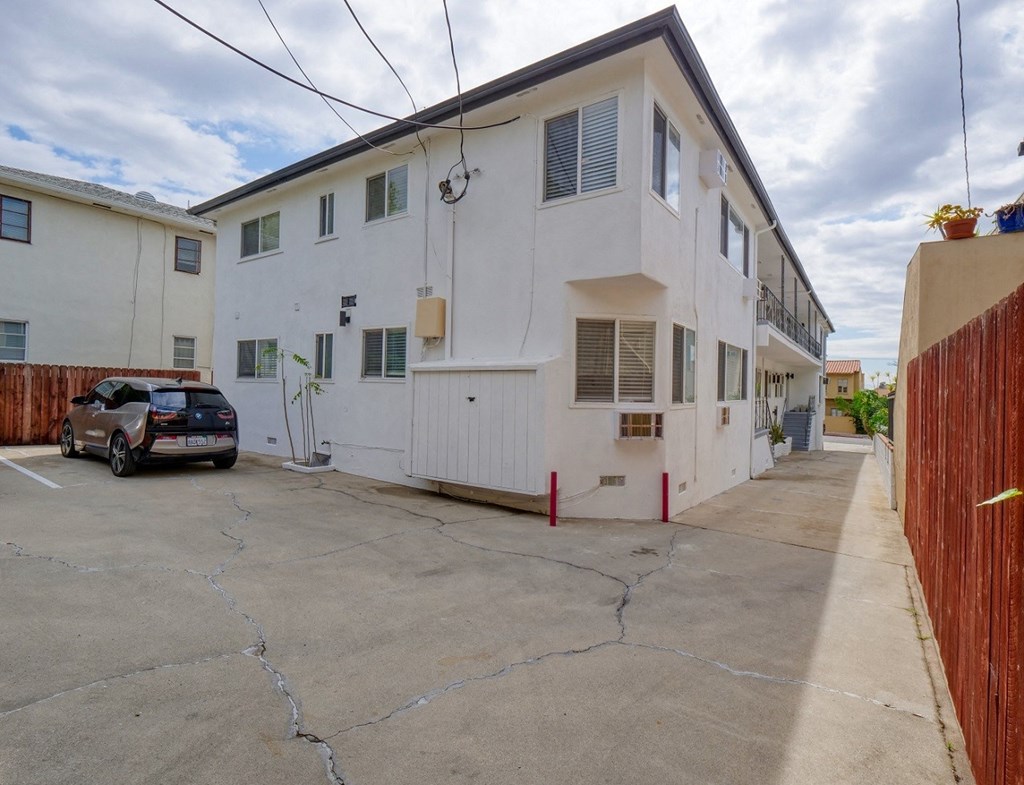 a white building with a car parked outside of it