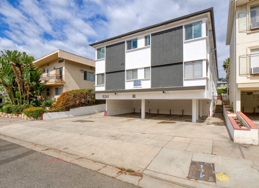 a street view of an apartment building with a driveway