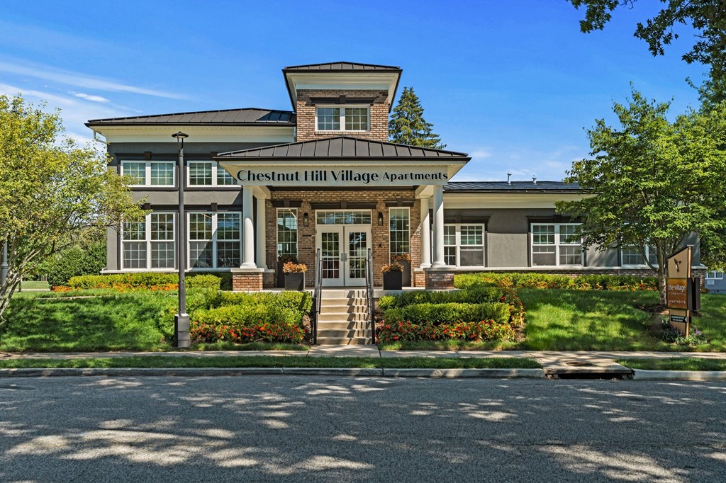 a large building with a sign on the front of it that says chesterfield hill village  at Chestnut Hill Village, Philadelphia, PA