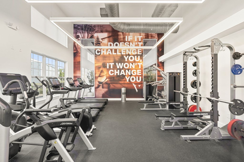 A gym with a sign that says "If it doesn't challenge, it won't change you."