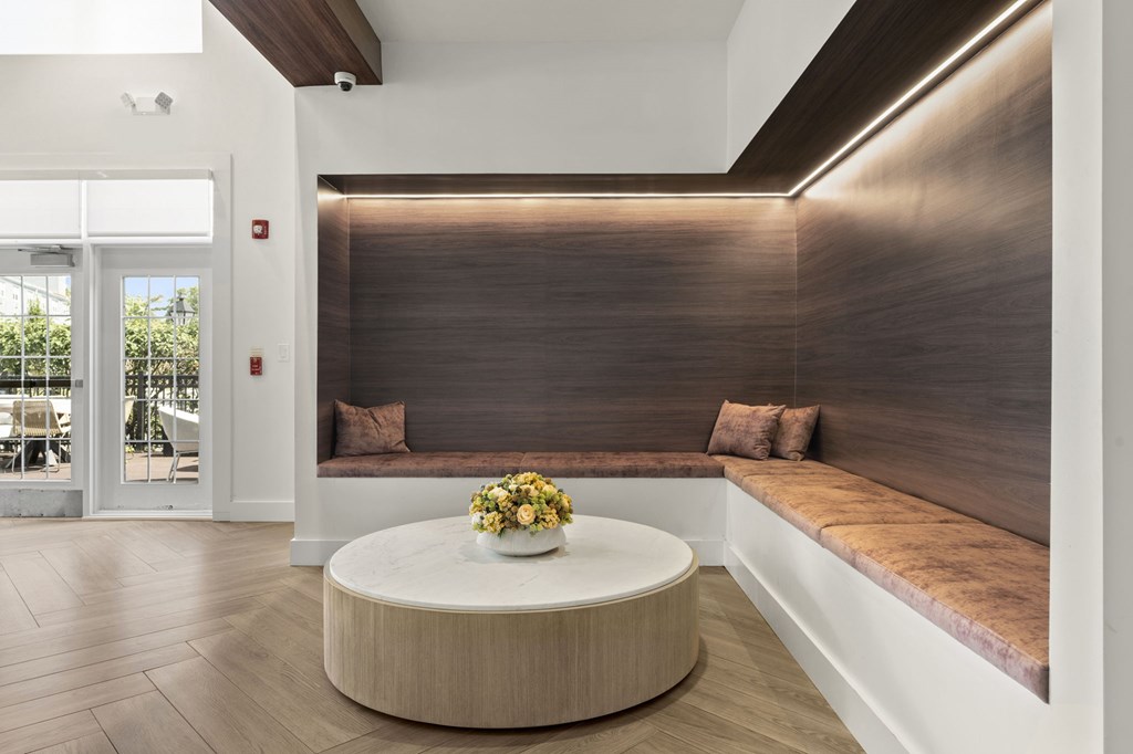 A modern living room with a wooden floor and a brown wall.