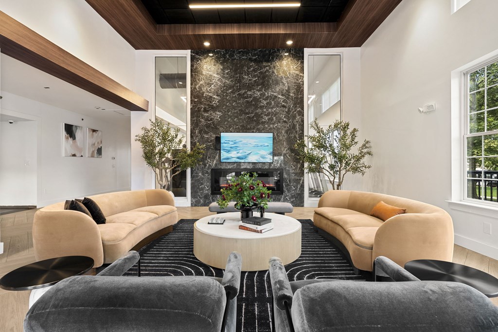 A modern living room with a large sofa set and a television.