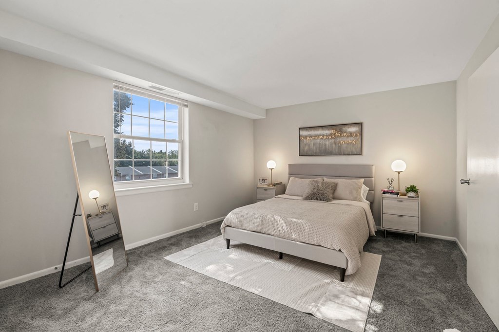 a master bedroom with a bed and a mirror