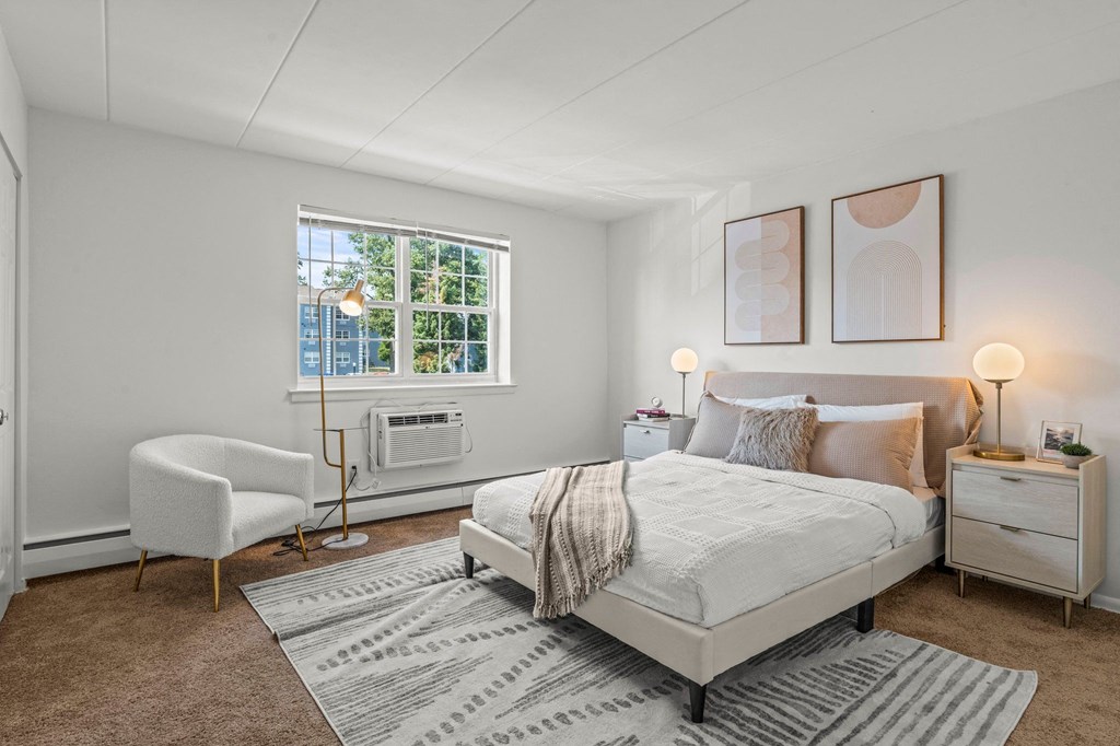 a bedroom with a bed and a chair  at Chestnut Hill Village, Pennsylvania