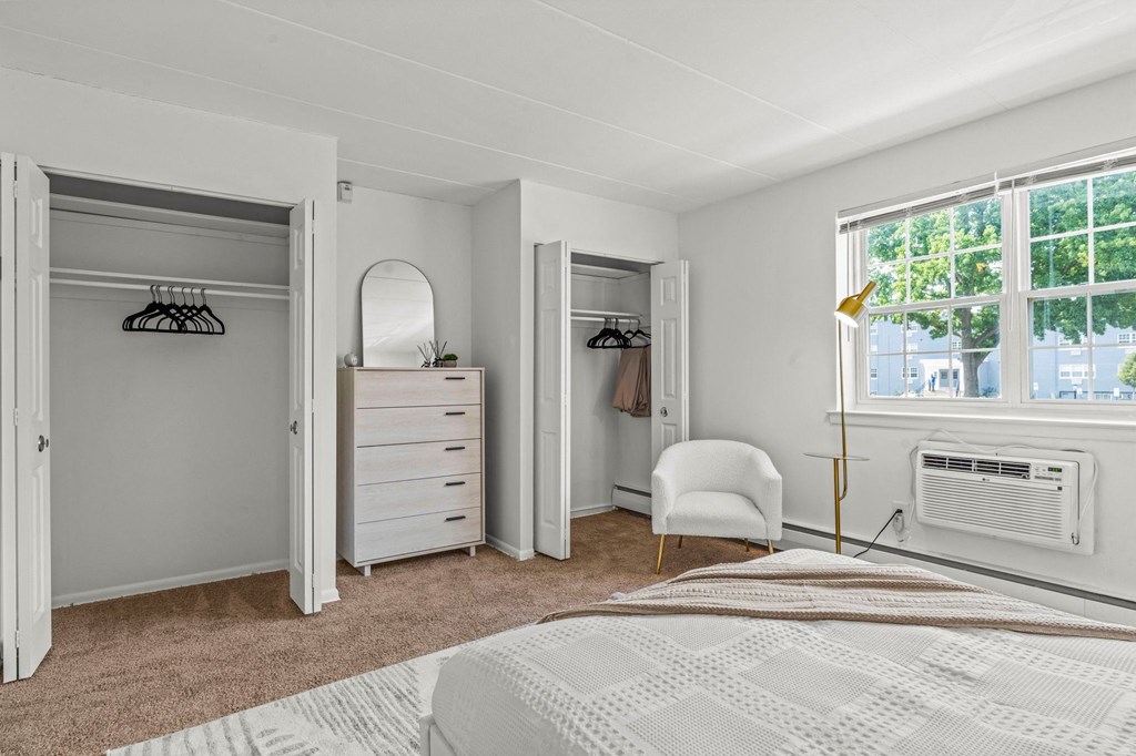 a bedroom with a bed and a dresser in front of a window  at Chestnut Hill Village, Pennsylvania, 19118