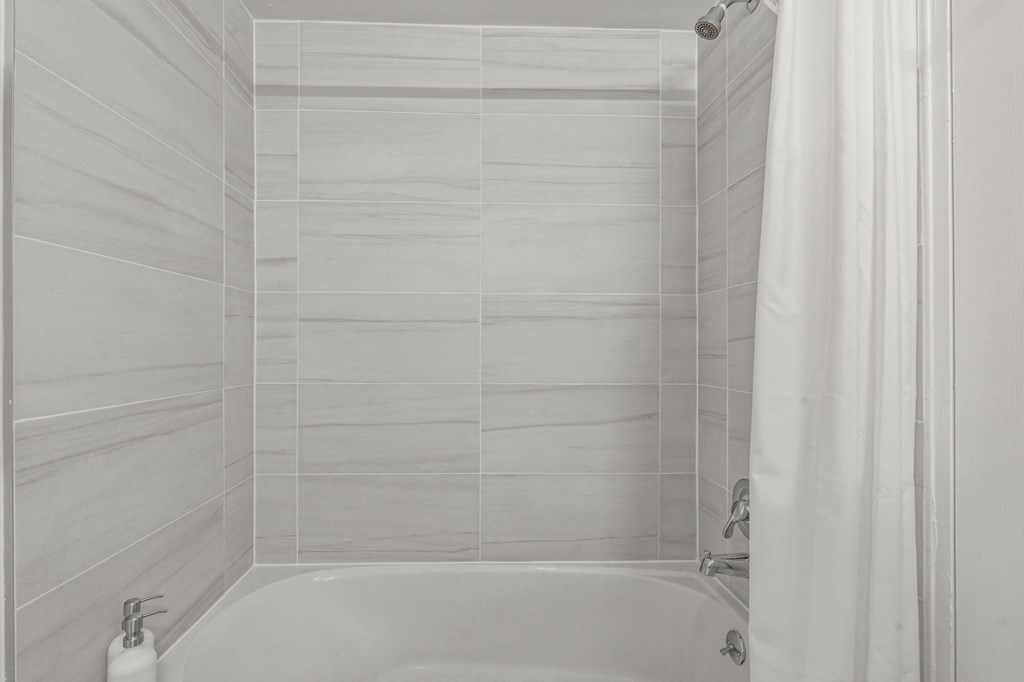 a bathroom with a bathtub and a shower curtain  at Chestnut Hill Village, Philadelphia, PA