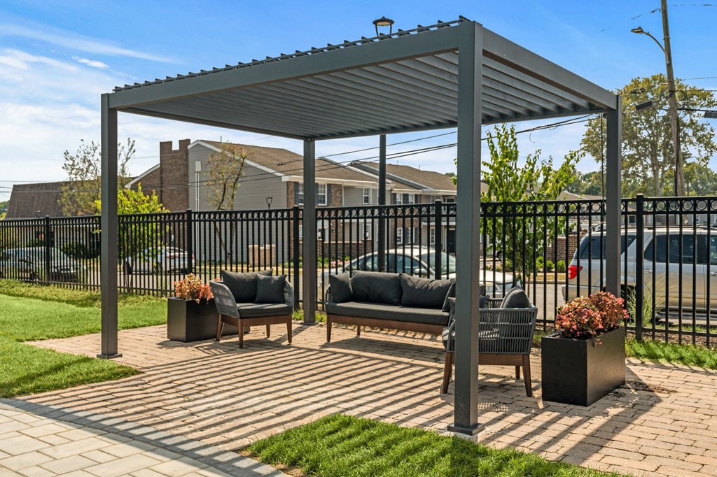 a pergola with two couches on a brick patio  at Chestnut Hill Village, Pennsylvania