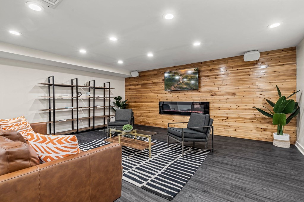 a living room with a fireplace and a wooden wall