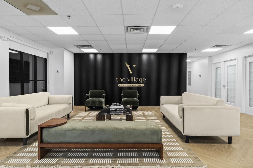 A black wall with "the village" written on it.