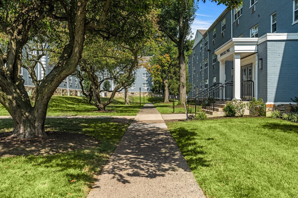 a pathway with trees and buildings on either side  at Chestnut Hill Village, Pennsylvania