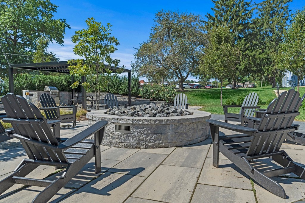 an outdoor patio with chairs and a fire pit  at Chestnut Hill Village, Philadelphia, PA