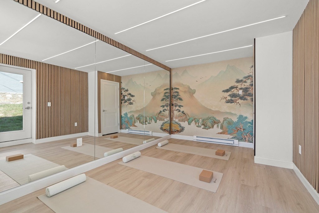 a room with yoga mats and a large mural on the wall at Chestnut Hill Village, Philadelphia, Pennsylvania
