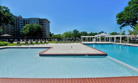a large pool with a pavilion and trees next to a building  at Parkview Towers, Collingswood, 08107