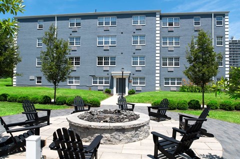 a patio with chairs and a fire pit in front of Chestnut Hill Villages, Philadelphia PA