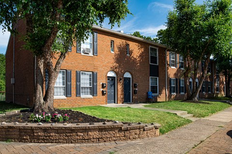 a large brick building with a tree in front of it
