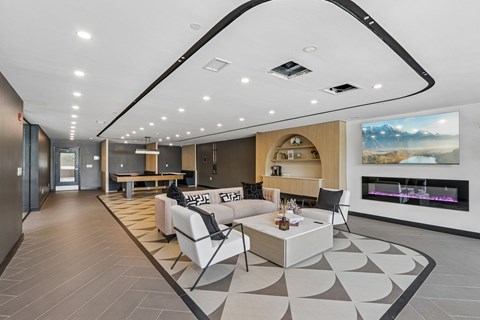 A modern living room with a fireplace and a large painting on the wall.