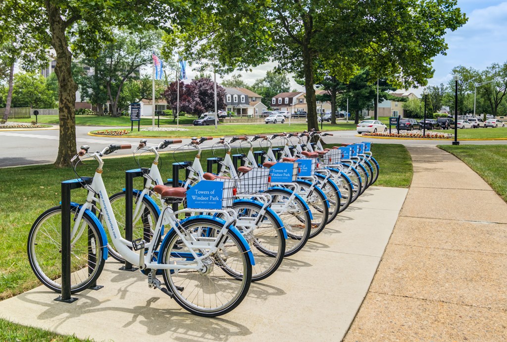 A row of bicycles are parked in a bike rack.