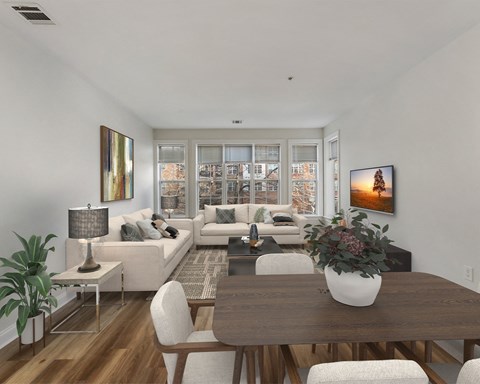 a living room and dining room with white furniture and a large window