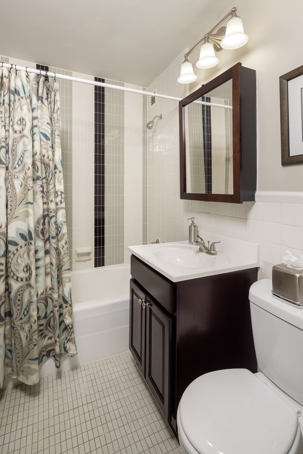 A bathroom with a white toilet, a sink, and a shower.