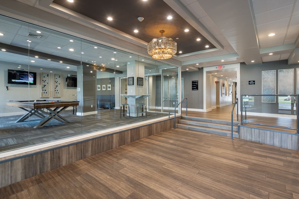 A room with a wooden floor and a glass wall.