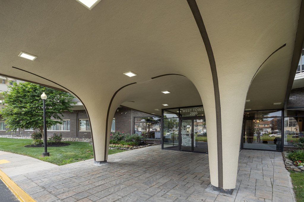 A building with a white canopy and glass doors.
