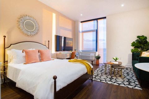 a bedroom with a bed and a large window at The Irvine, Philadelphia