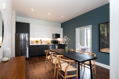 a kitchen and dining room with a table and chairs