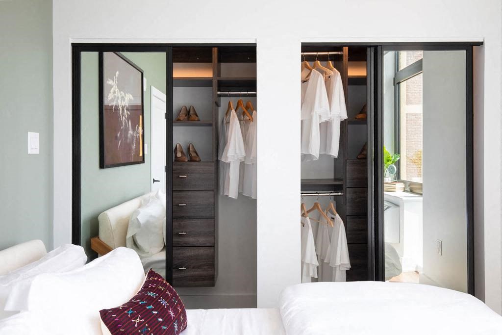a bedroom with a closet full of clothes and a bed a bedroom with a closet full of clothes and a bed at The Irvine, Philadelphia, Pennsylvania