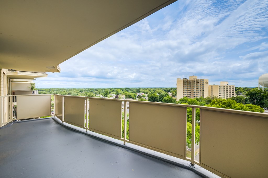 A balcony with a view of a cityscape.