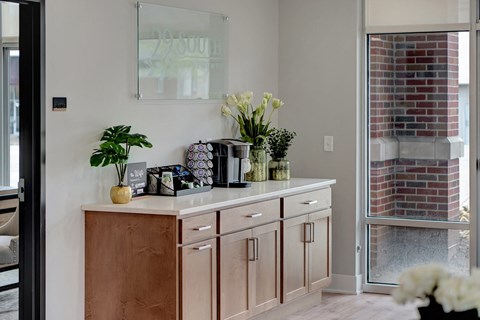 a kitchen with wooden cabinets and a counter with vases and flowers